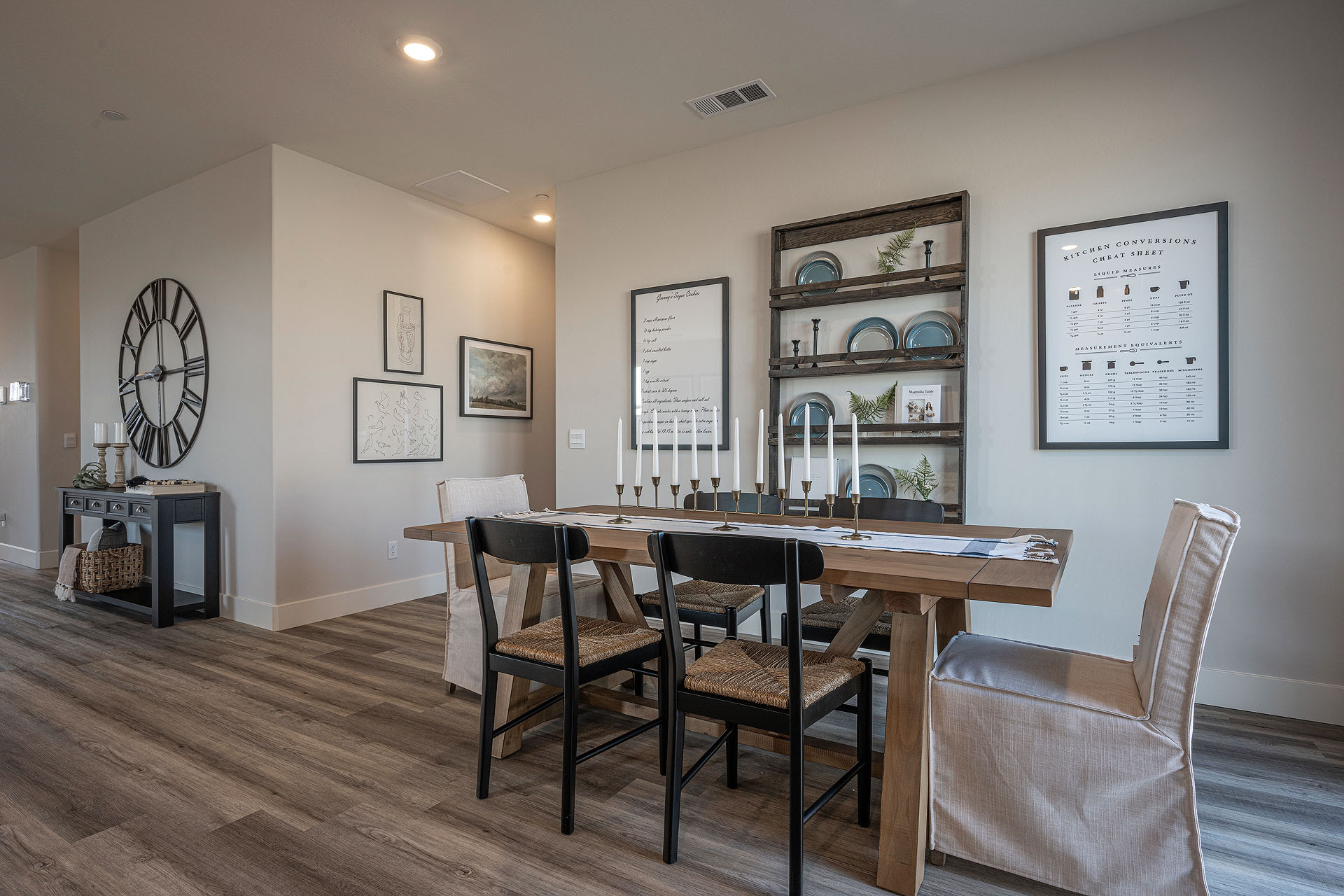 Interior photo of dining room with dining table, chairs, and art on the wall.