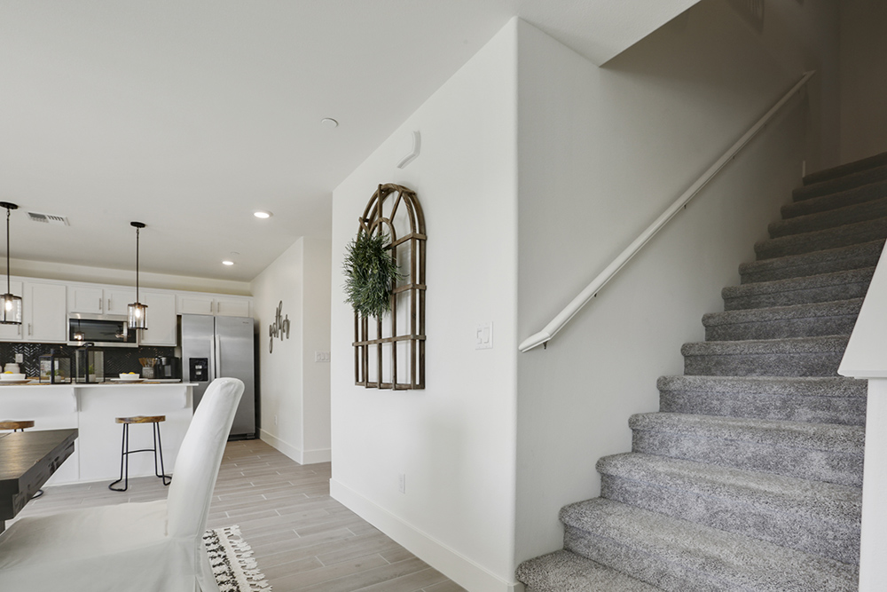 Interior photo of entryway to home and stairway leading to second story.