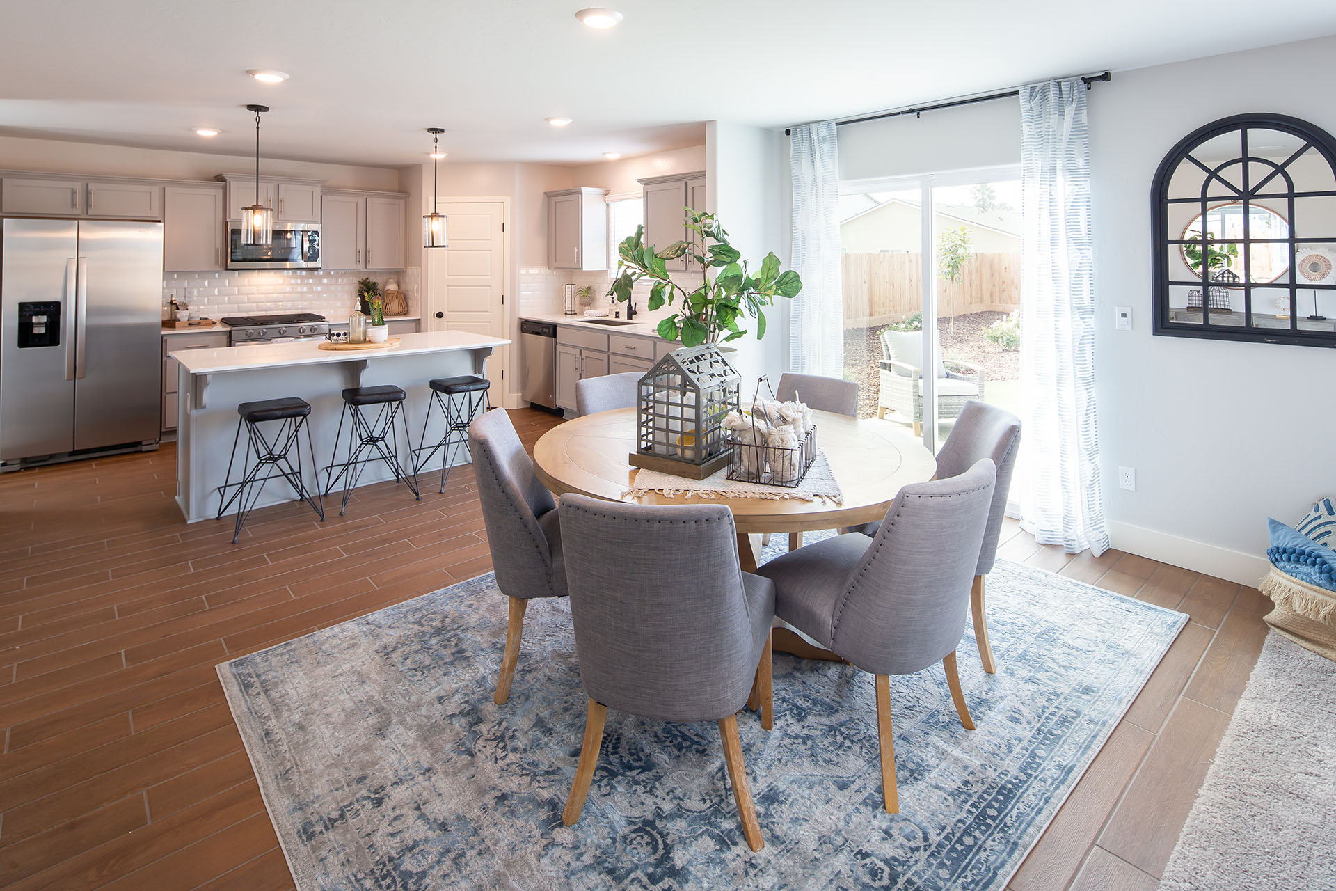 Interior photo of open concept breakfast nook with table, chairs, and rug