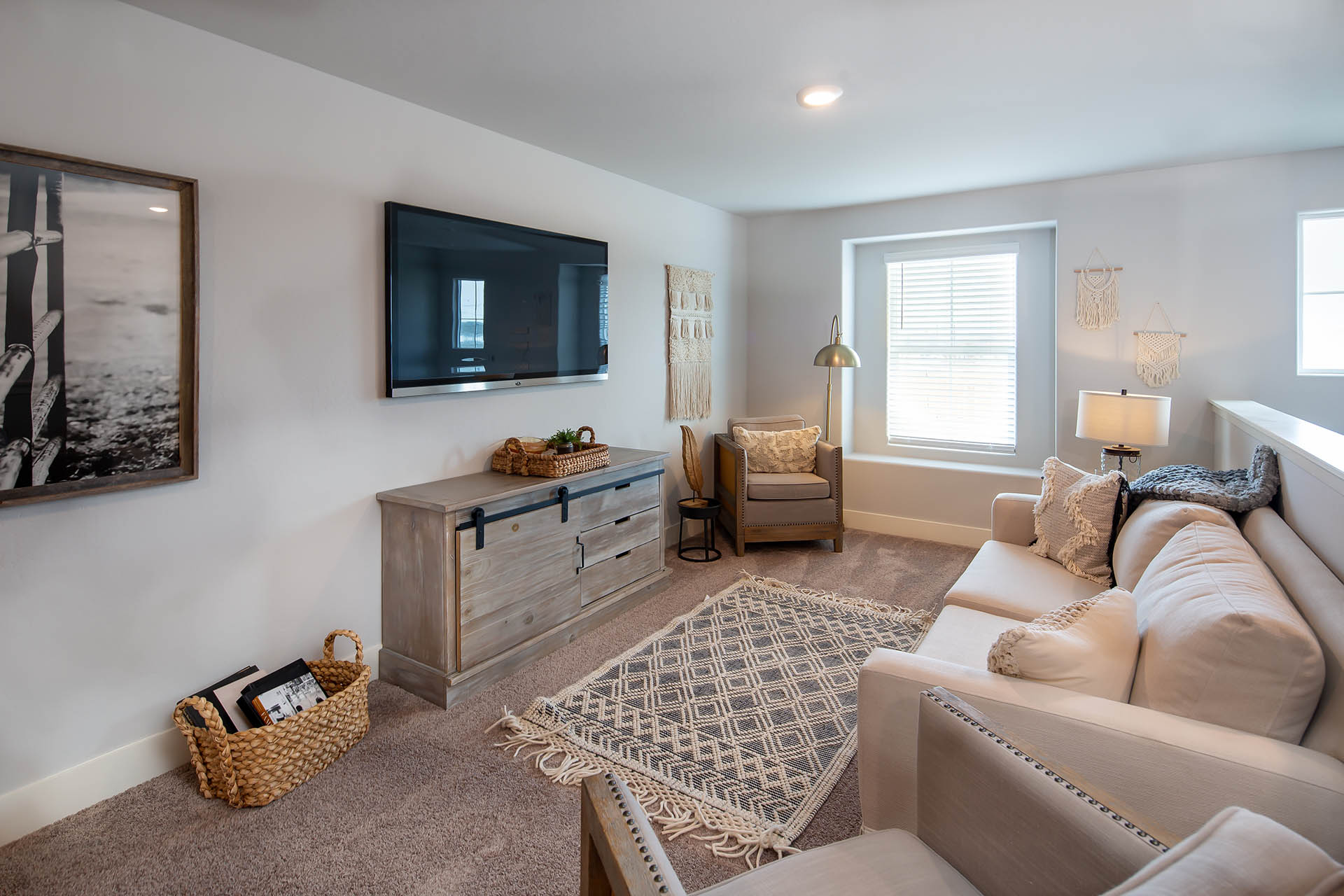 Interior photo of loft with couch, tv, and storage cabinet.