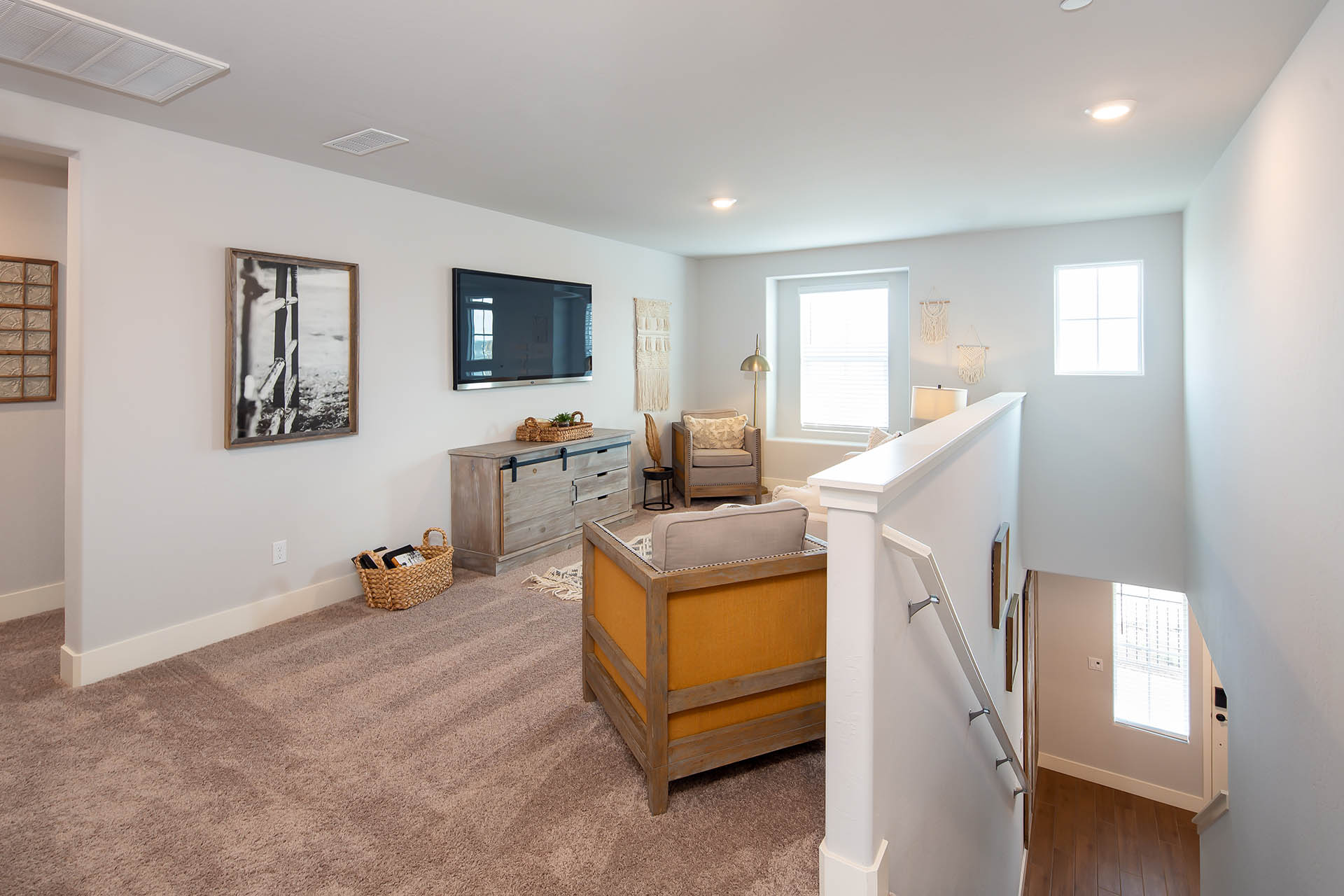 Interior photo of loft with couch, tv, and storage cabinet.