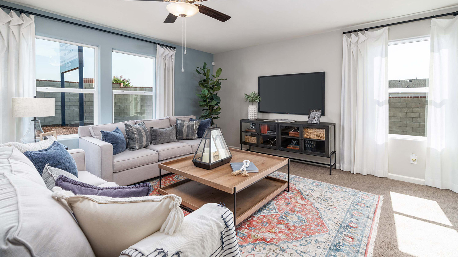 open concept living room with seating and entertainment center