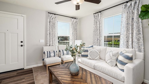 Photo of sitting room in entry-way with couch and coffee table