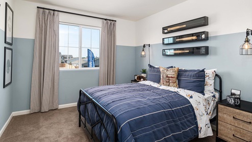 Interior photo of kid's bedroom with blue decor and a large window