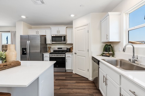 Kitchen with natural lighting and white cabinets