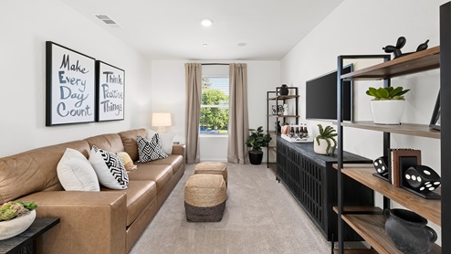 Photo of upstairs loft with a couch and entertainment center