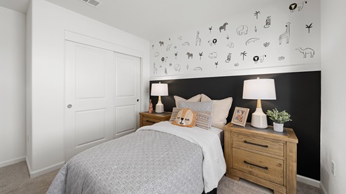 Photo of kids bedroom with matching end tables and decorative wallpaper