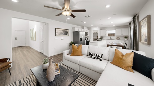 Photo of open concept living room with a couch, coffee table, and entertainment center