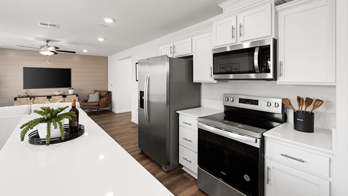 Photo of open concept kitchen with white countertops and white cabinets