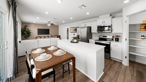 Photo of open concept kitchen with white countertops and white cabinets