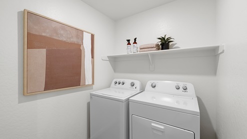 Photo of laundry room with washer, dryer and storage shelf