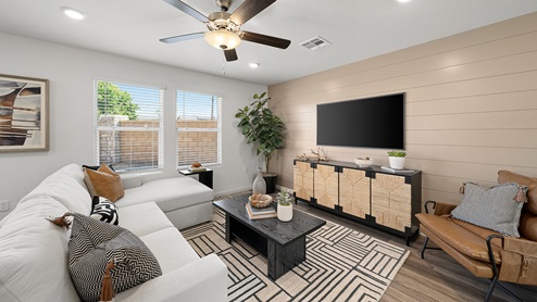 Photo of open concept living room with sectional couch, coffee table and entertainment center