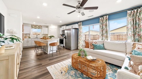 Photo of open concept living room with sectional couch, coffee table and entertainment center