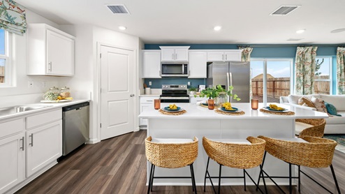 Photo of open concept kitchen with white countertops and white cabinets