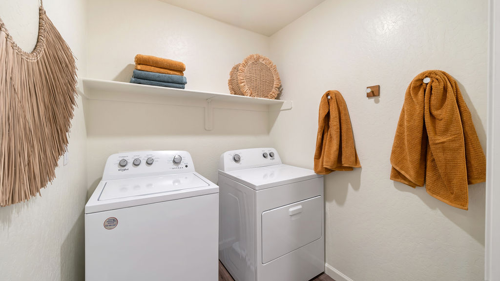 laundry room with washer, dryer and storage shelf
