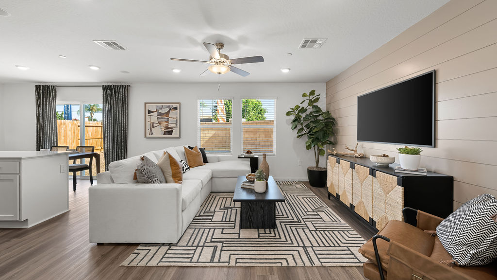 open concept living room with seating and entertainment center