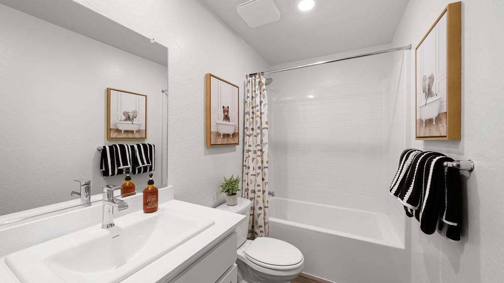 guest bathroom with white countertops and white cabinets