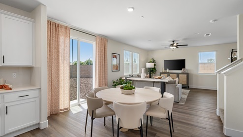 Photo of open concept dining room and kitchen with sliding glass door leading ot backyard