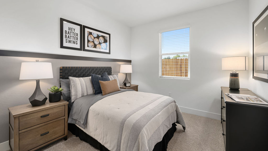 guest bedroom with full sized bed and accent wall