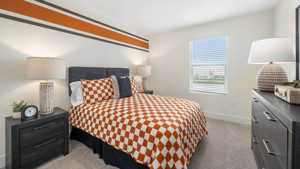 kid's bedroom with orange decor and accents