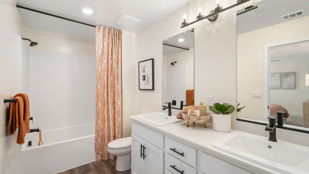 Primary bathroom with orange accents