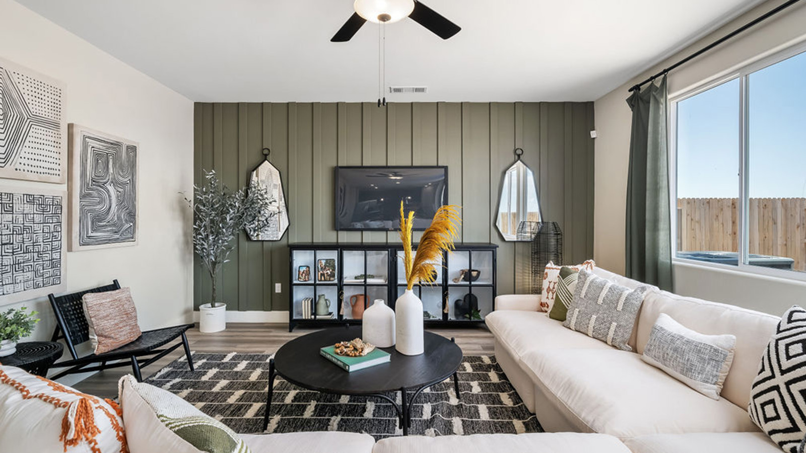 Living room with large sectional couch and green shiplap accent wall