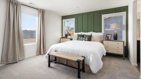 Primary bedroom with large windows and a king size bed