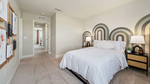 Photo of guest bedroom with green accent paint on wall