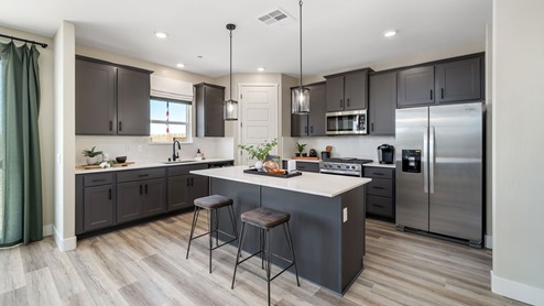 Photo of open concept kitchen with large island and gray cabinets