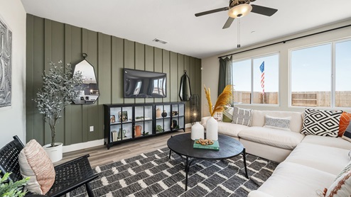 Photo of open concept living room with large sectional couch and large windows