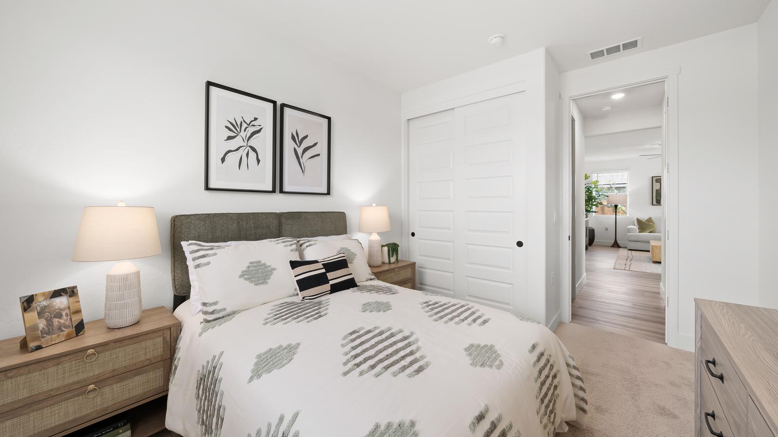 Interior photo of guest bedroom with full size bed and matching endtables