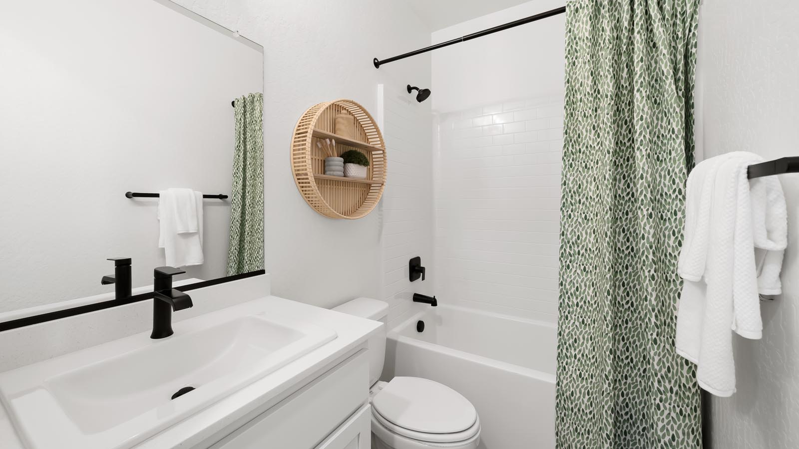Interior photo of guest bathroom with white cabinets and countertops