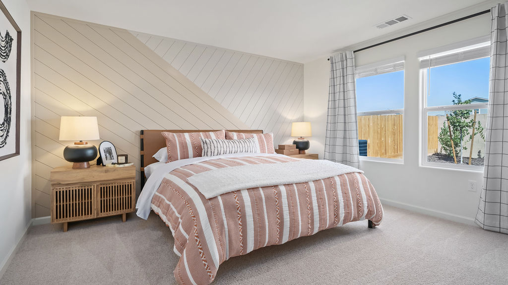 Primary bedroom with peach bedding.