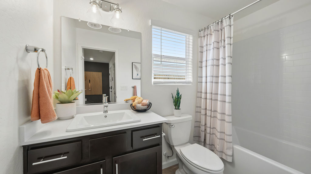 Guest bathroom with peach accents.