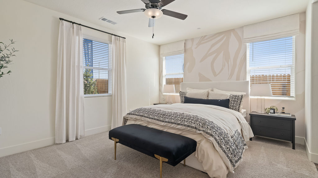 Primary bedroom with white and blue bedding.