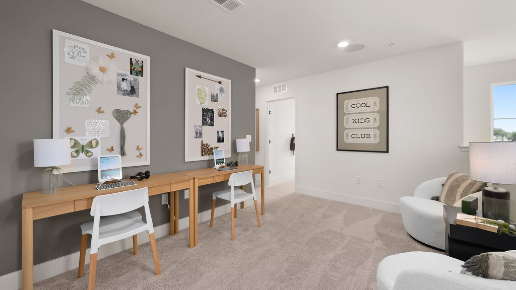 Upstairs loft with brown desk.