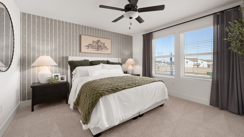 Primary bedroom with white and green beddding.