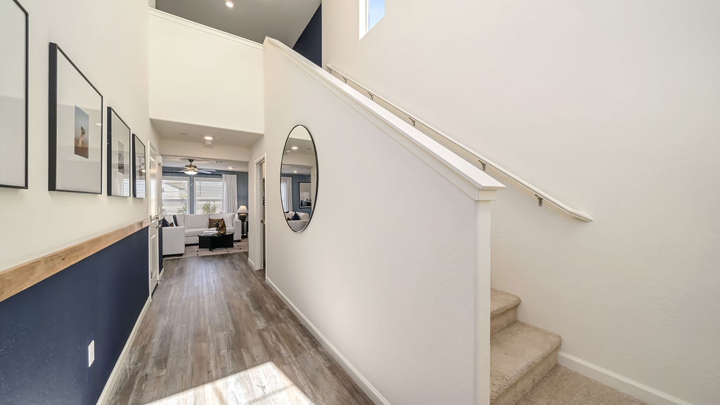 Entry way with round mirror.
