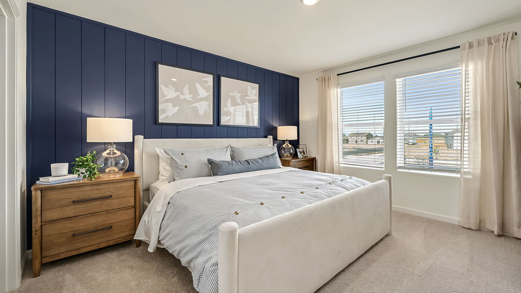 Primary bedroom with a blue accent wall.