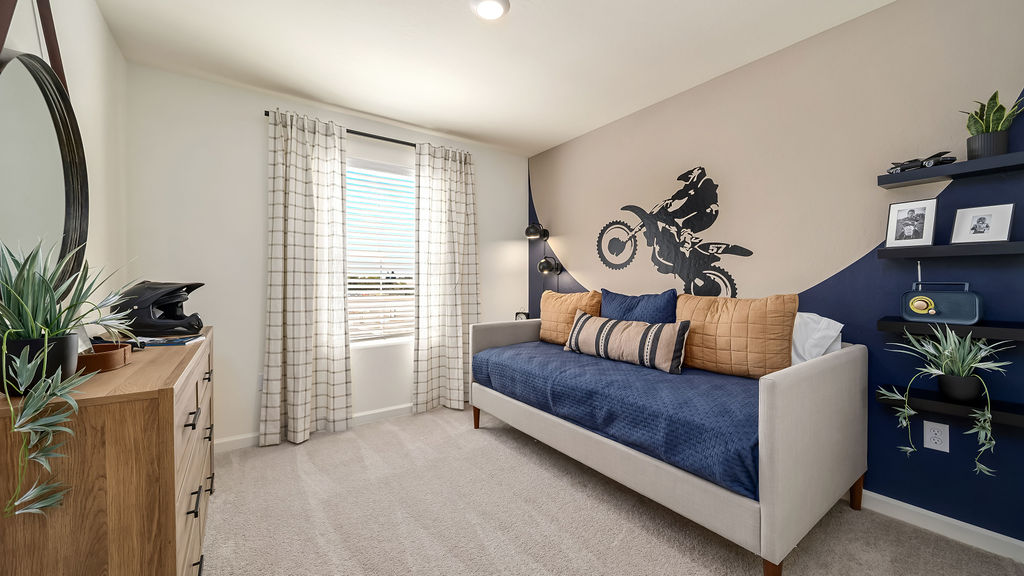 Kids room with blue and grey bedding.