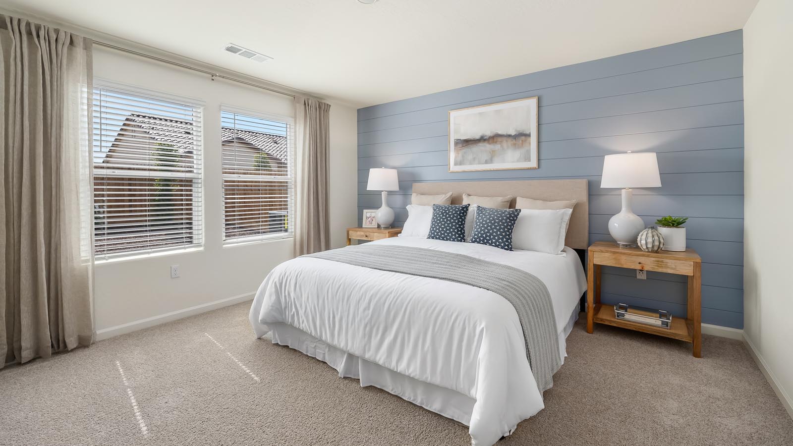 Primary bedroom with king sized bed and matching end tables