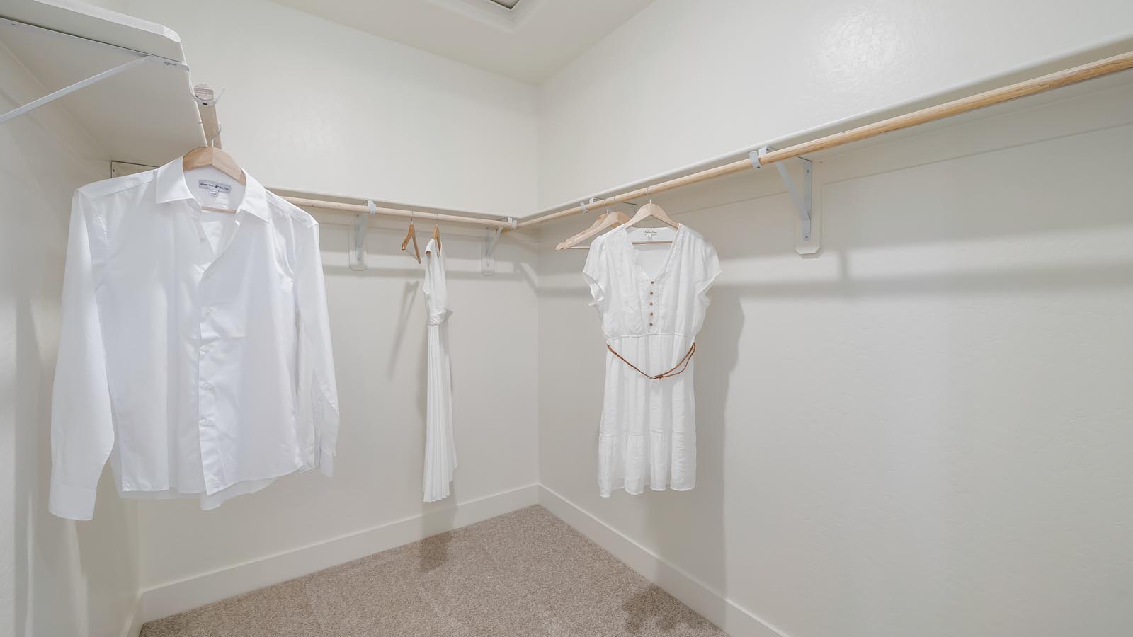 Interior photo of walk-in closet of primary bedroom