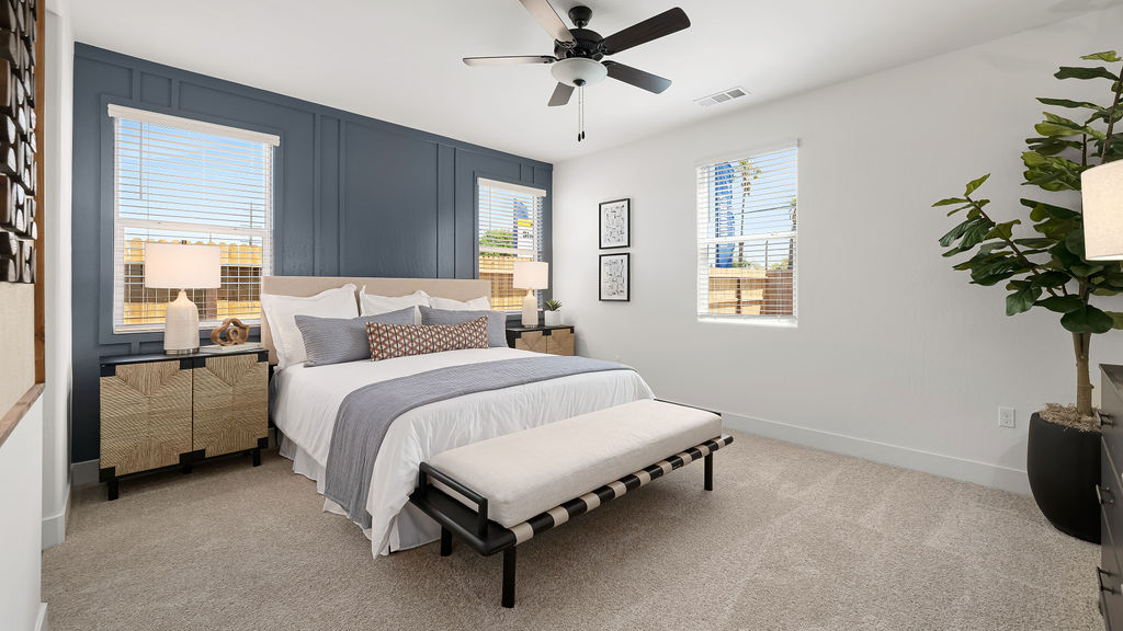 bedroom with blue accent wall and white bedding.