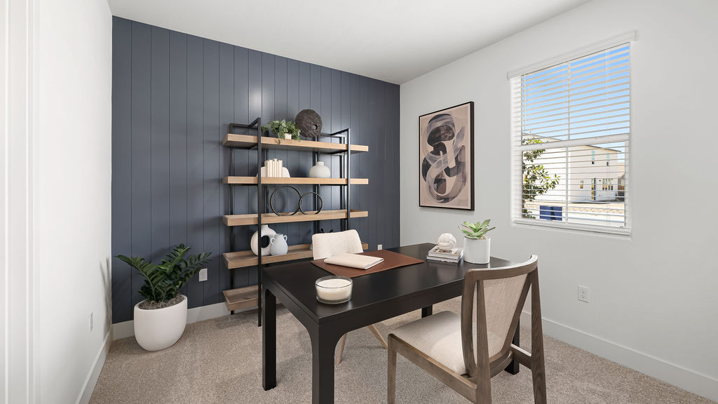 office with blue accent wall and dark brown desk.