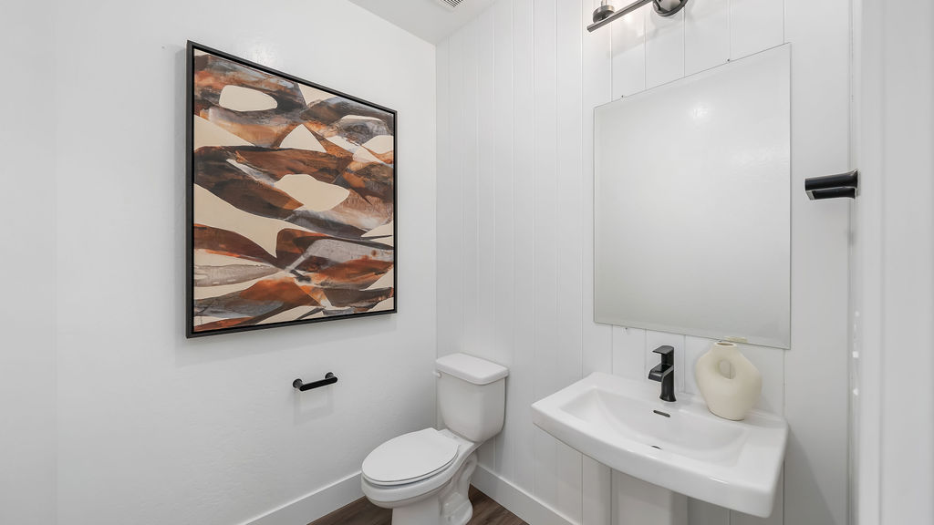 bathroom with wall art.