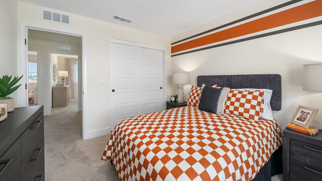 kids bedroom with orange checkered bedding.