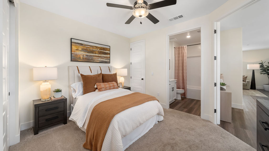 bedroom with white and orange bedding.