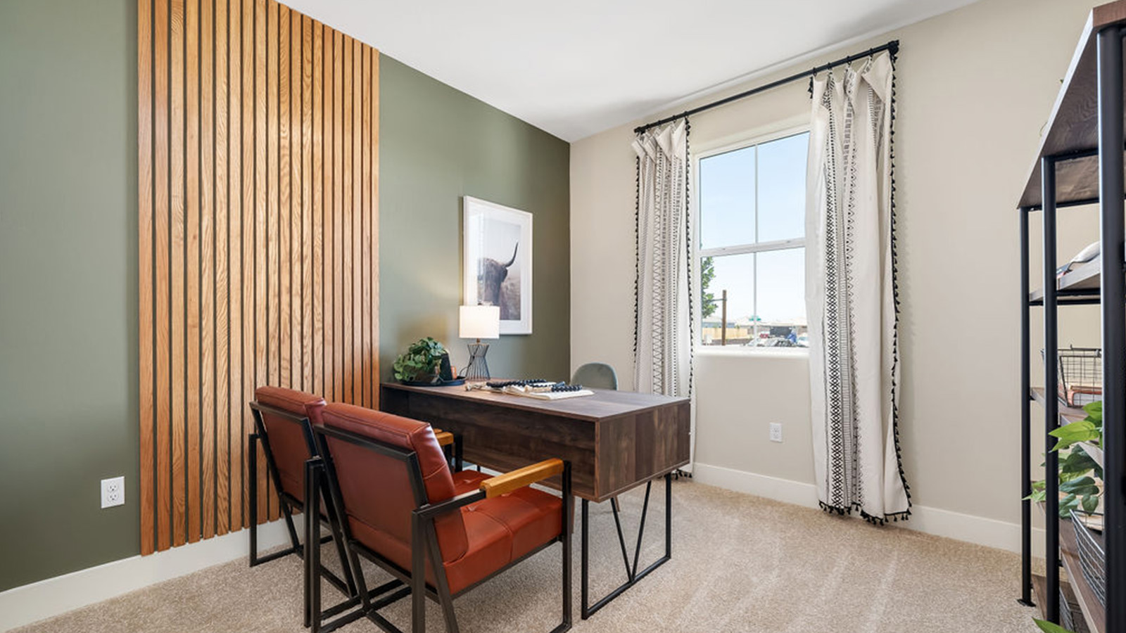 home office with grey desk and green accent wall.