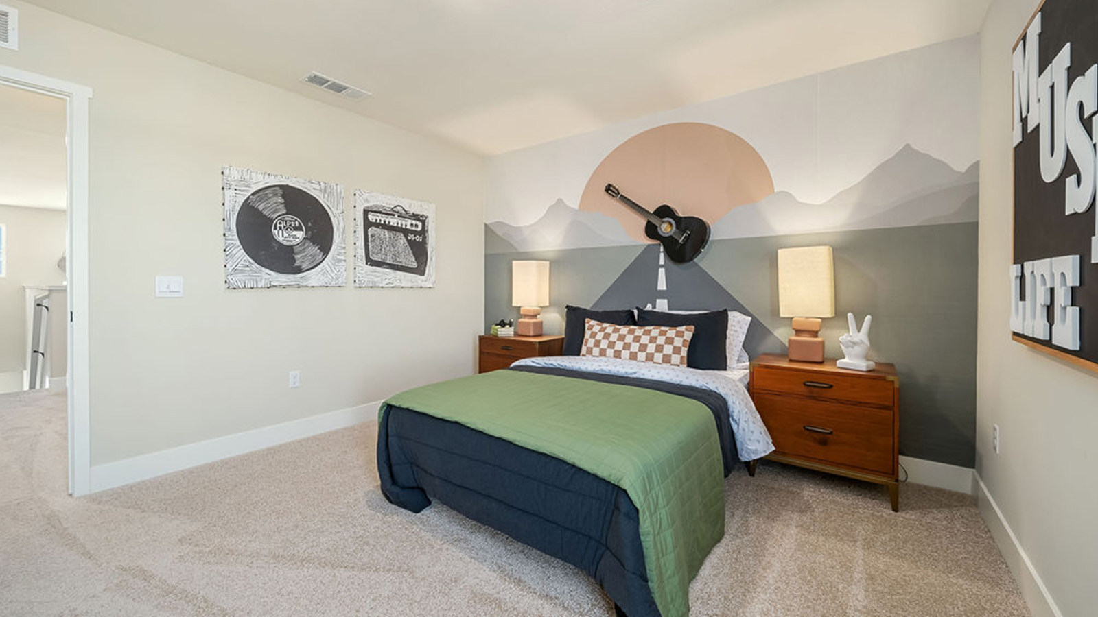 kids bedroom with green bedding and wall accents.