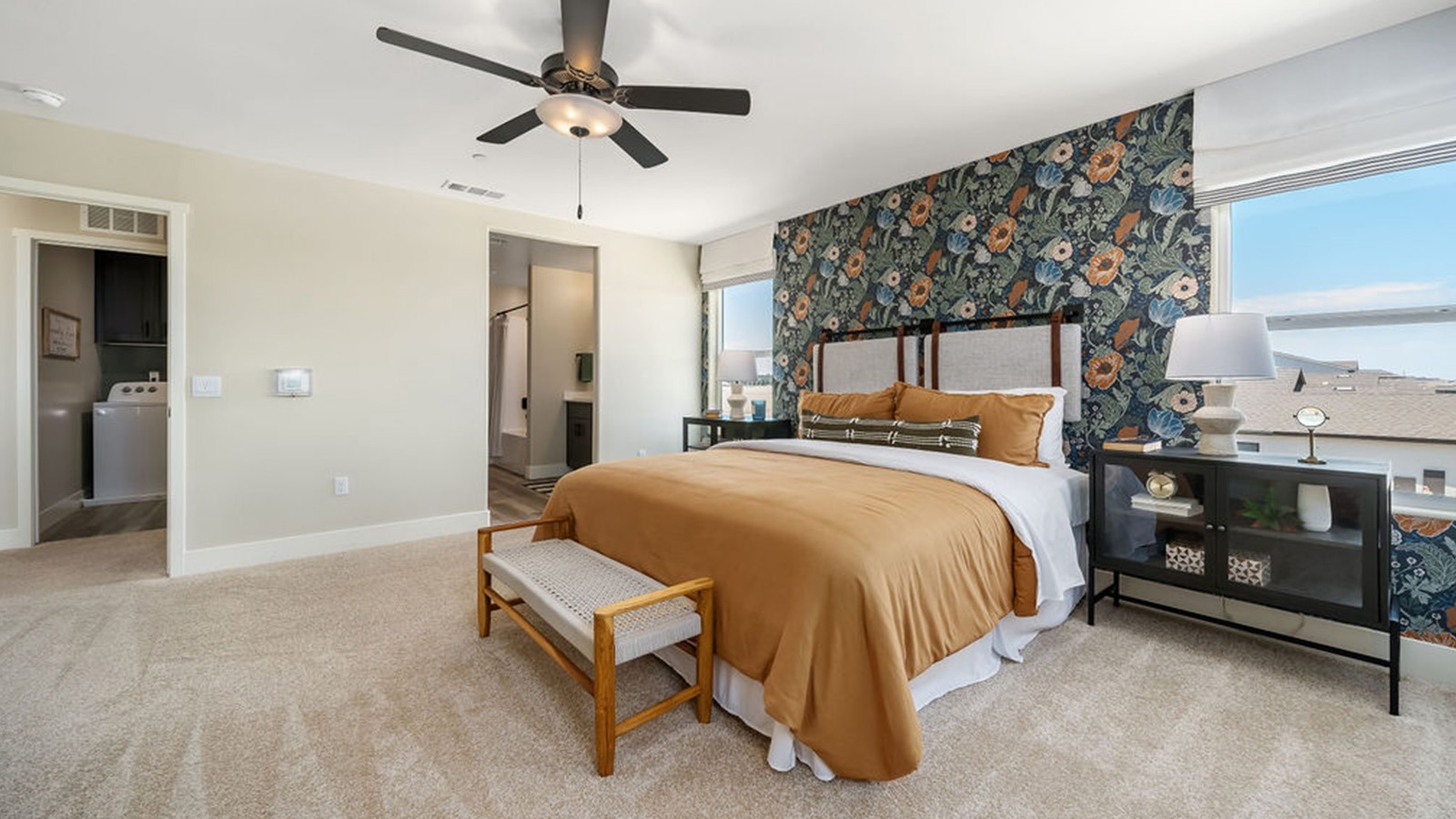 primary bedroom with tan bedding.